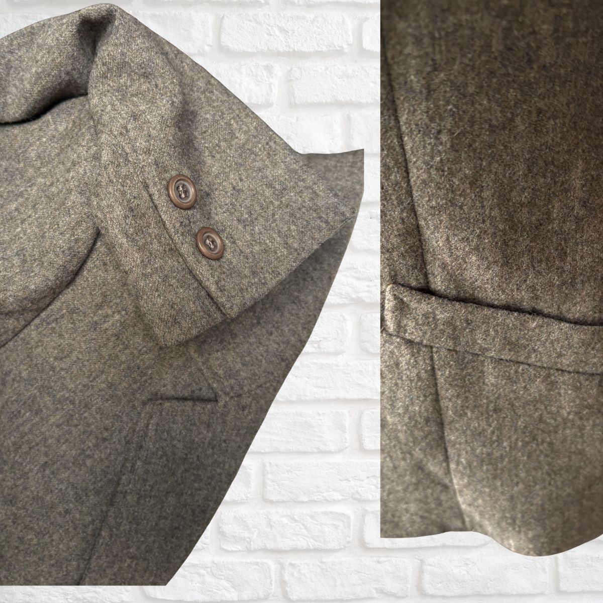 Close-up of a grey/brown textured fabric with buttons and a belt on a white brick background