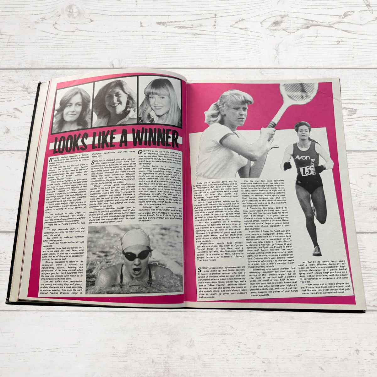 Open book with black and white photos and text on a pink background