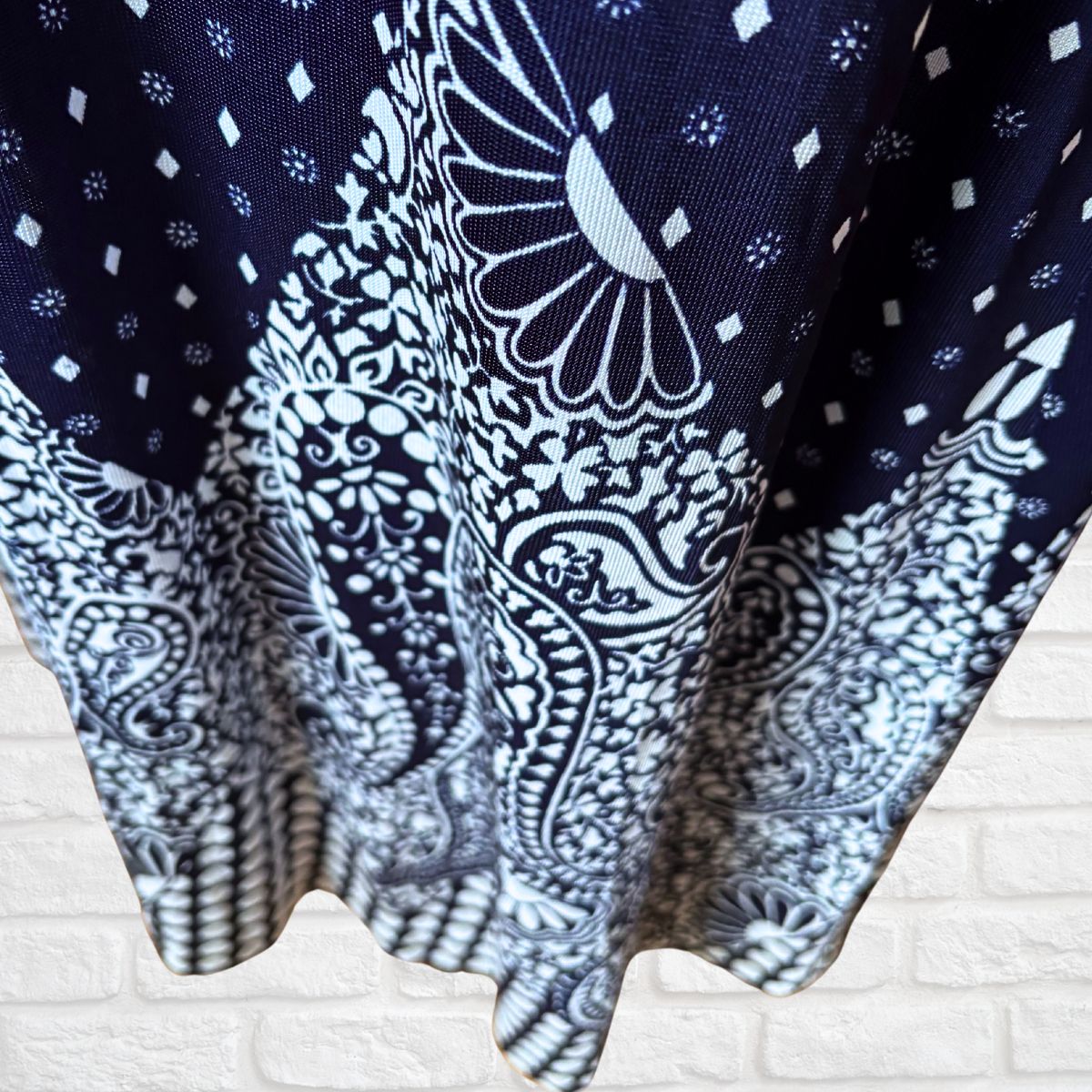 Navy blue fabric with white paisley patterns on a textured surface