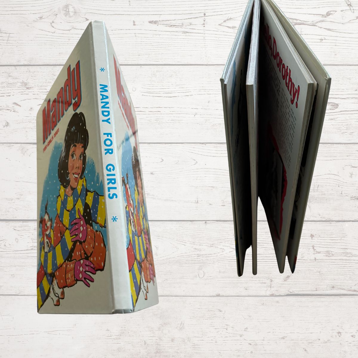 Vintage book titled 'Mandy for Girls' with a colorful cover on a light wooden surface.