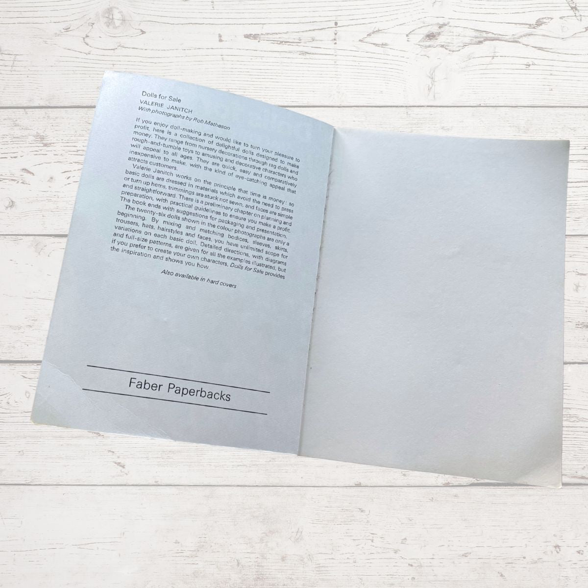 Open book with text on a light wooden surface