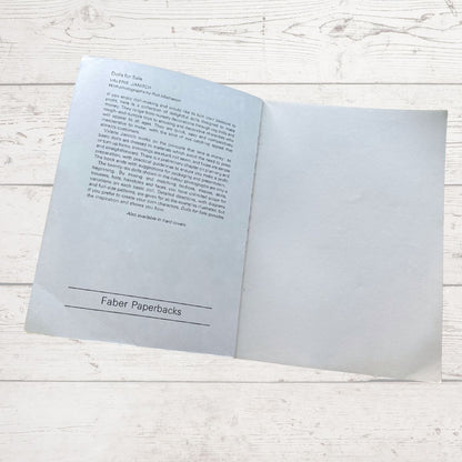 Open book with text on a light wooden surface