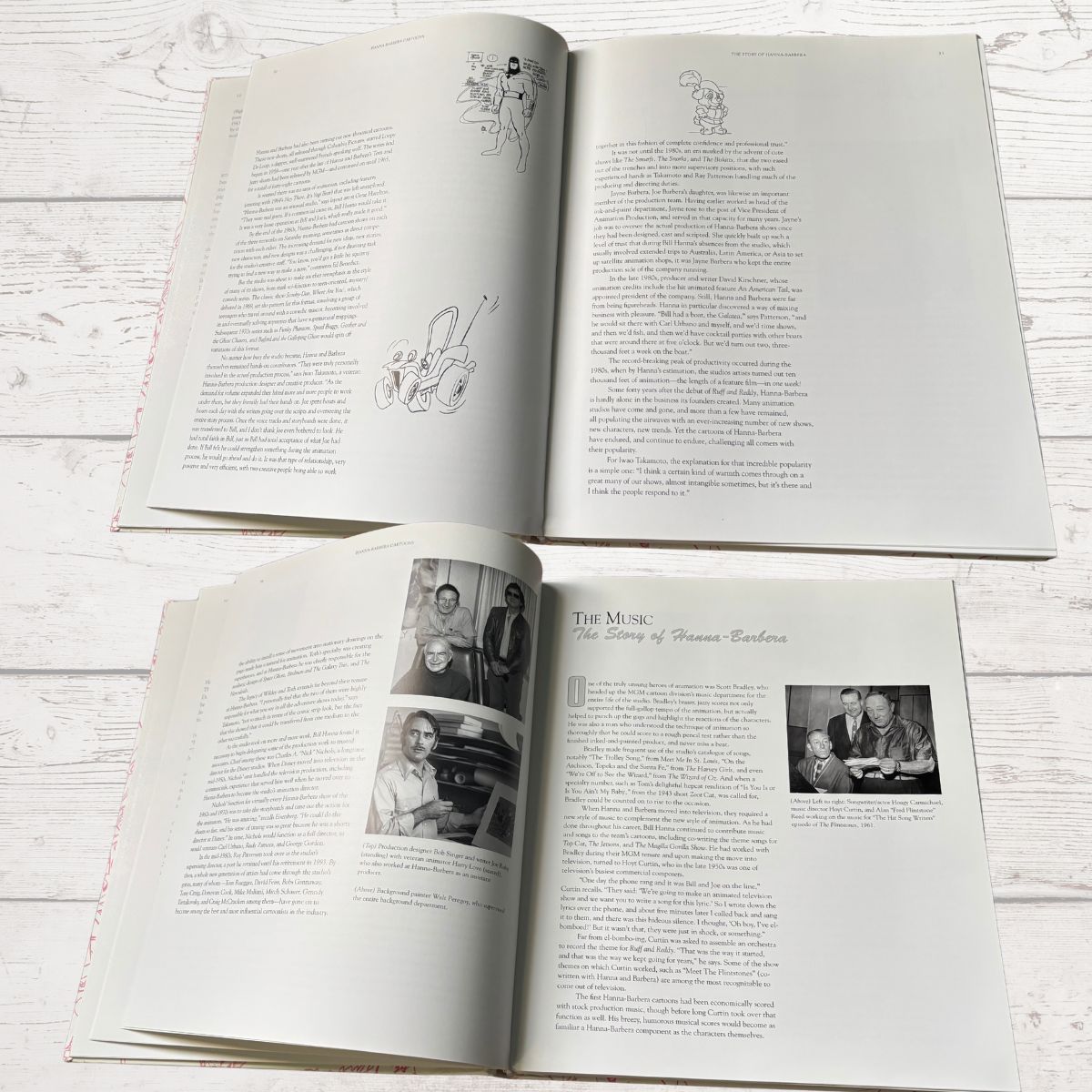 Open book on a light wooden surface with text and images.