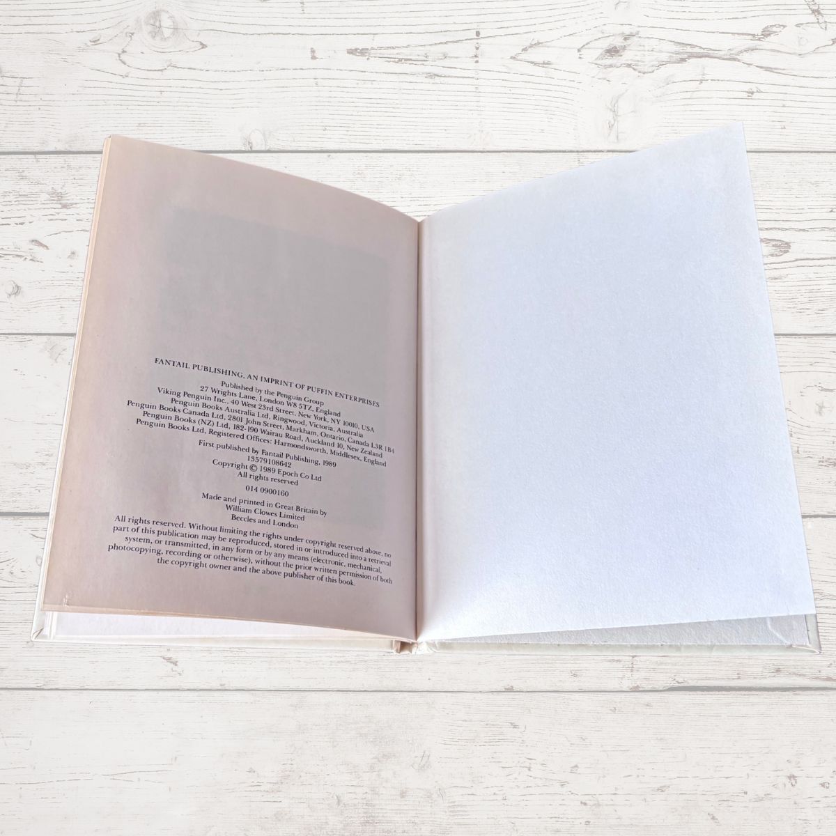 Open book with text on a wooden surface