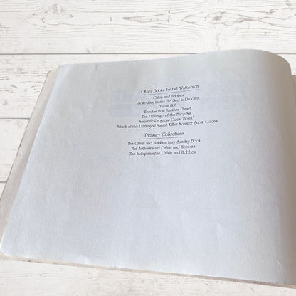 Open book with text on a light wooden surface