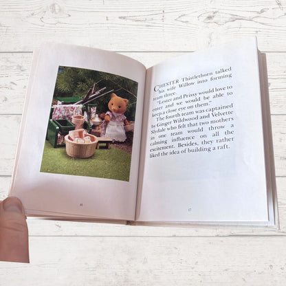 Open book with a picture of a teddy bear and text on a wooden surface