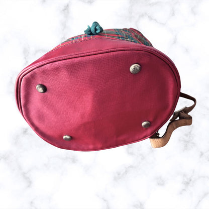 Red plaid bag with metal studs on a white marble background