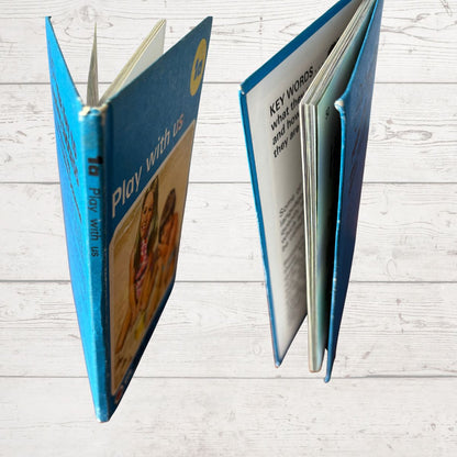 Open book with blue cover on a light wooden surface