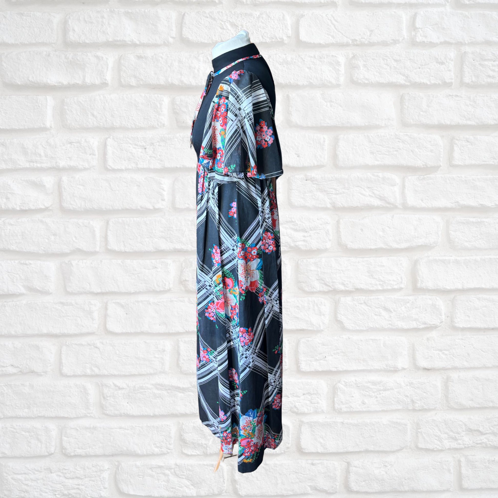  70s vintage maxi dress by Richard Shops with black high neck bodice and floral skirt - side view 