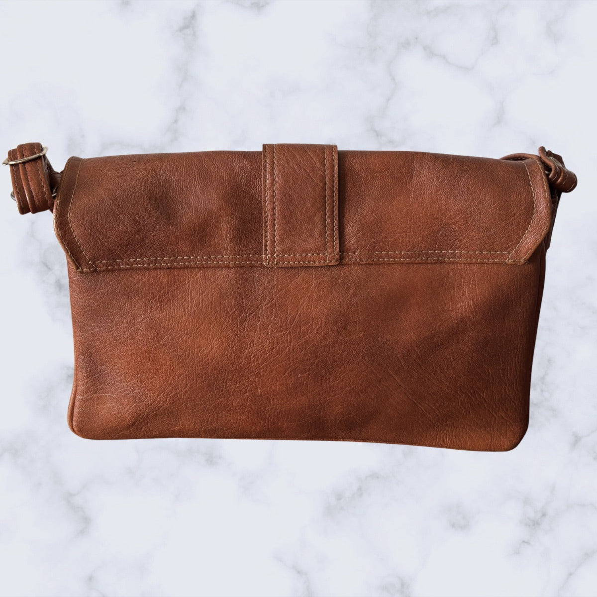 Brown leather bag on a marble background
