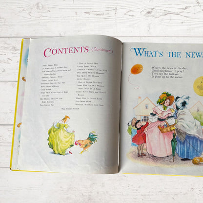 Open book with illustrated pages on a wooden surface