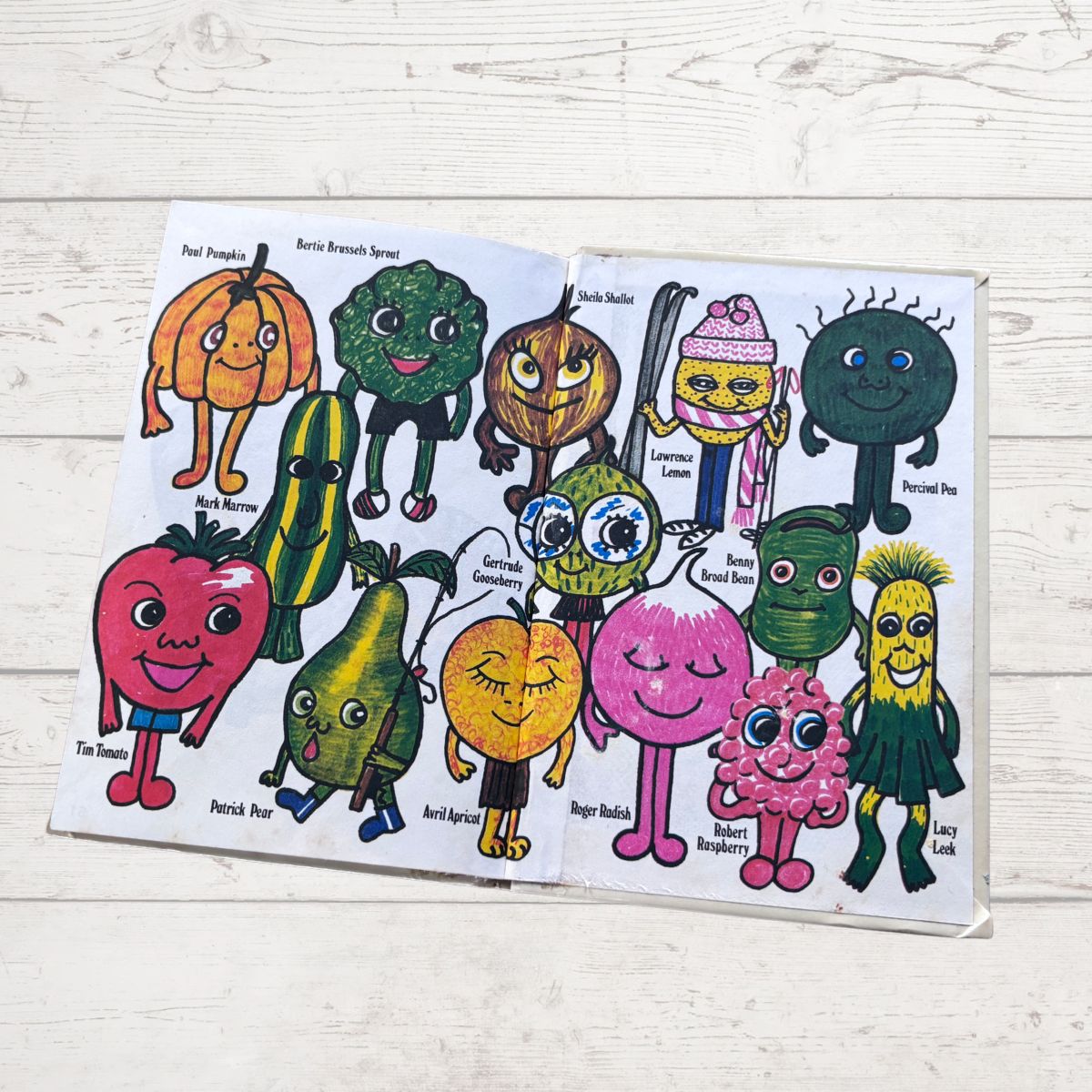 Colorful  cartoon vegetable characters on a white wooden surface