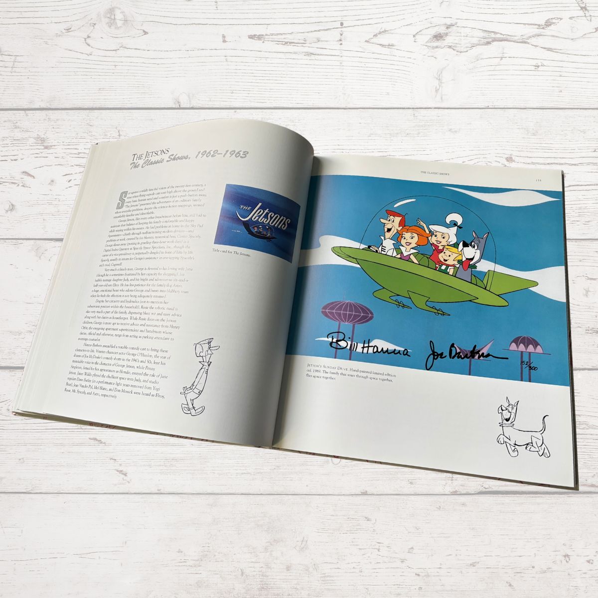 Open book with cartoon illustration of characters on a surfboard, featuring the Hanna-Barbera logo.