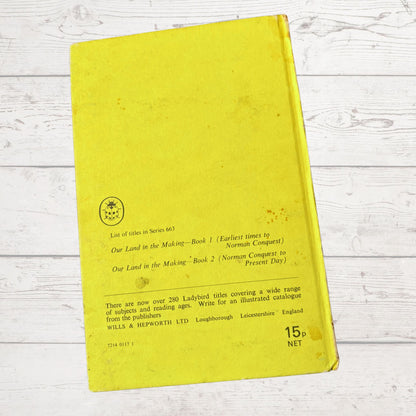 Yellow book with text on a light wooden surface