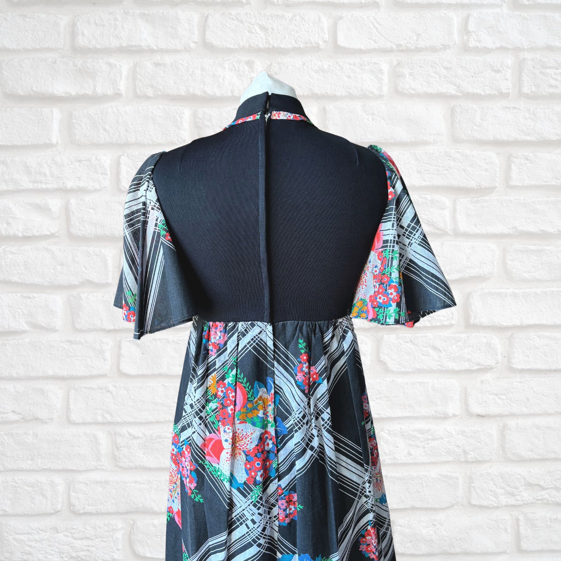 70s vintage maxi dress by Richard Shops with black high neck bodice and floral skirt - top back view 