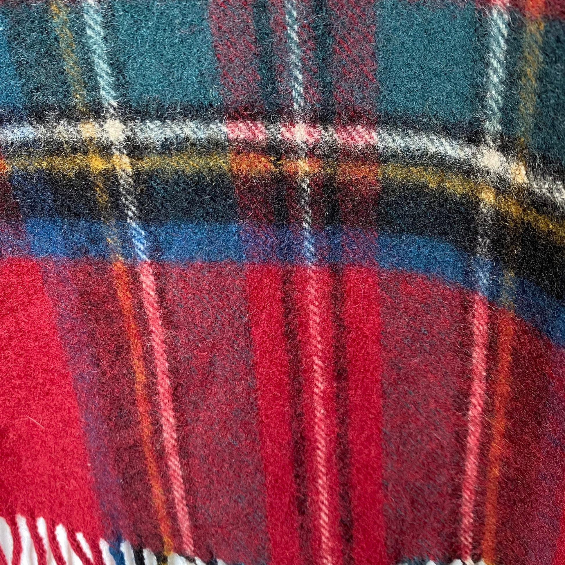 Close up of tartan wool scarf tiny hole 