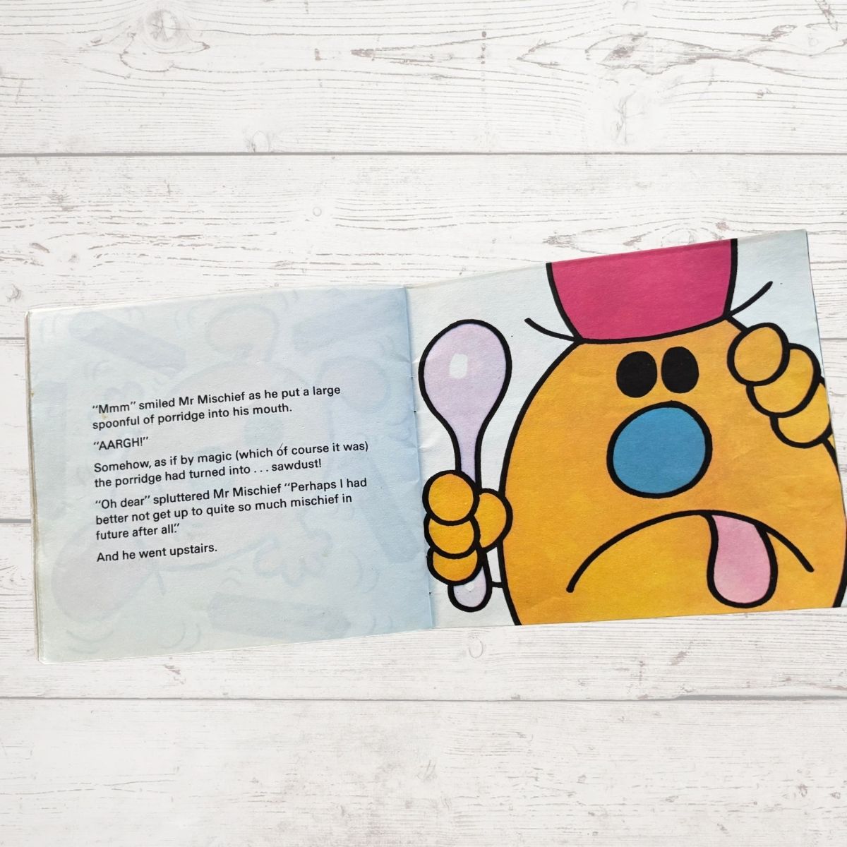 Comic book page with a cartoon character holding a spoon on a wooden surface