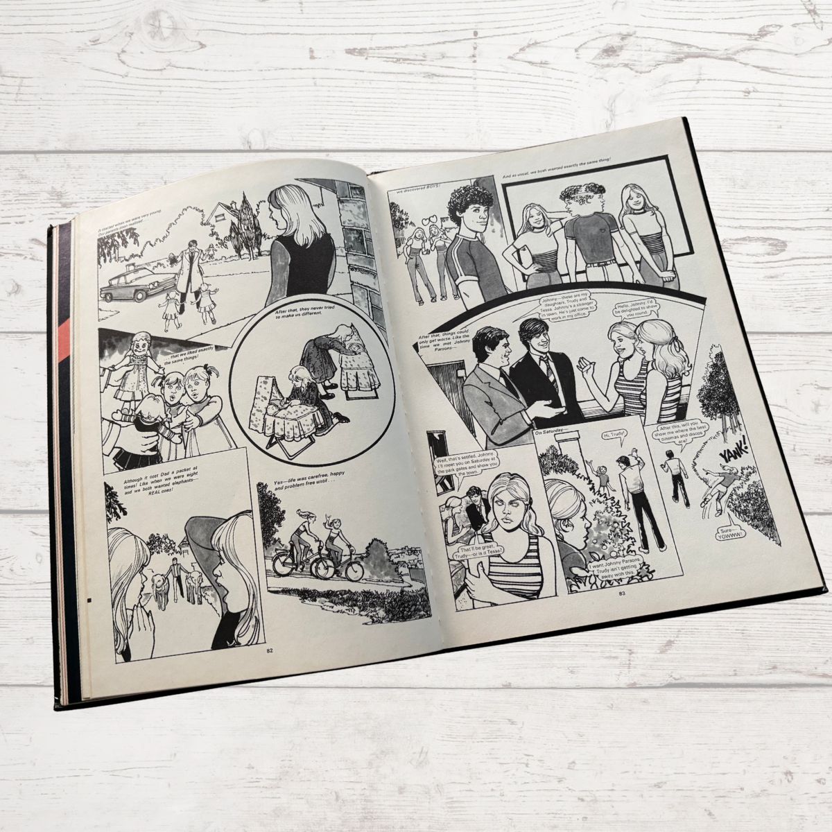 Open comic book on a wooden surface