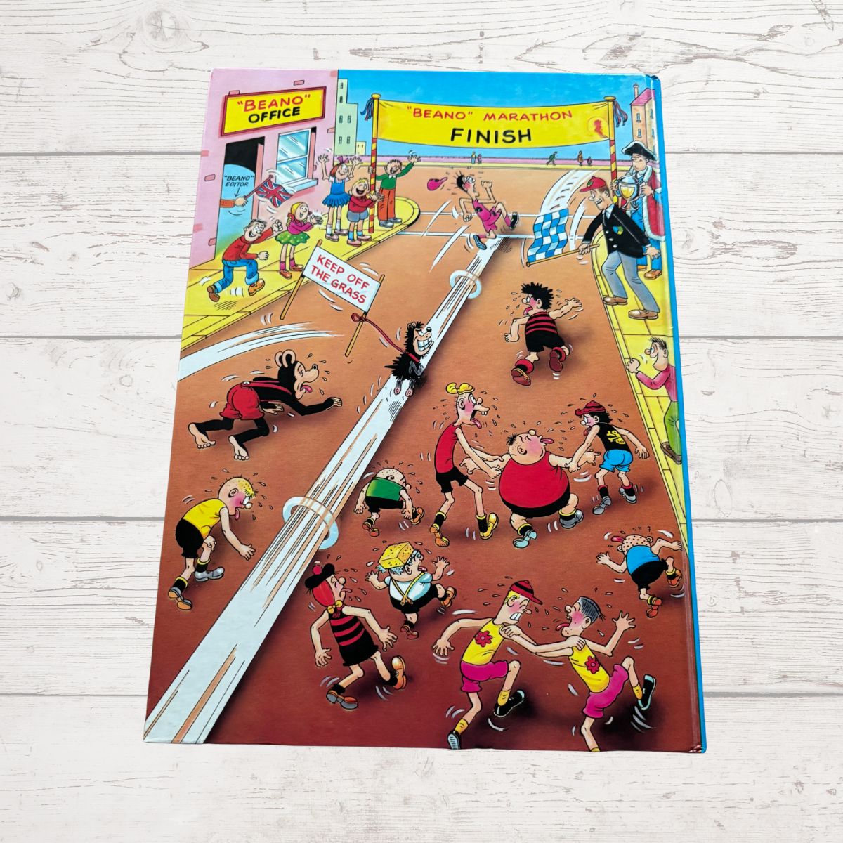 Comic book cover with cartoon characters running a marathon on a wooden surface