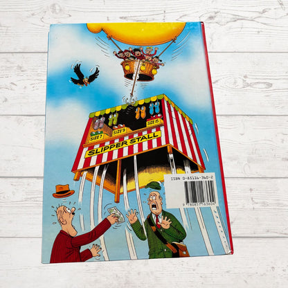 Cartoon book cover with a slipper stall and people in a hot air balloon on a wooden surface
