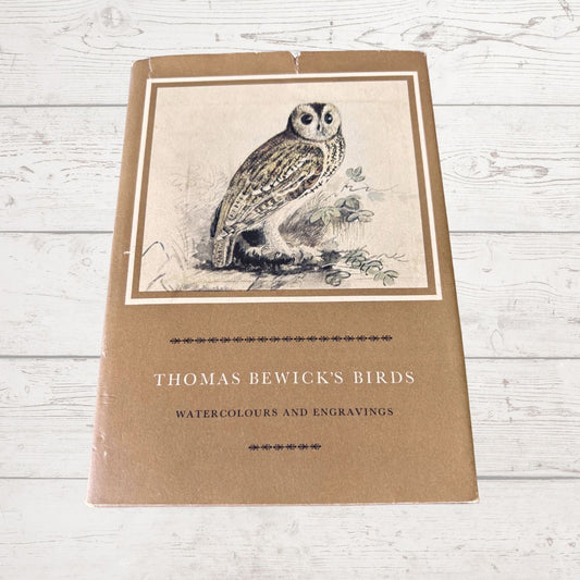 Book cover with an owl illustration and text on a wooden surface