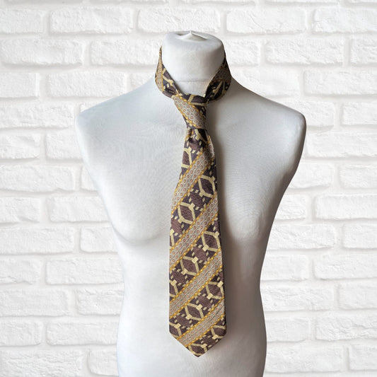 Patterned tie on a mannequin against a white brick wall background