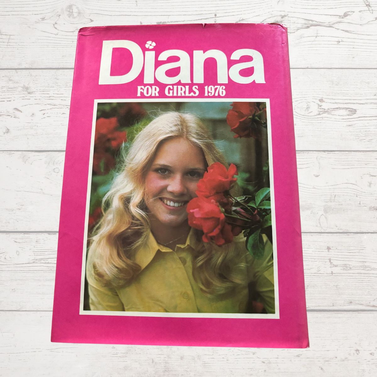 Vintage Diana annual 1976 on a white wood background 