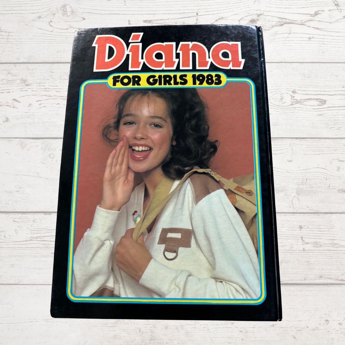 cover featuring a girl with text 'Diana for Girls 1983' on a wooden surface
