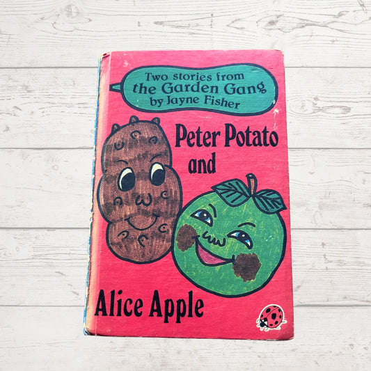Children's book titled 'Peter Potato and Alice Apple' on a wooden surface