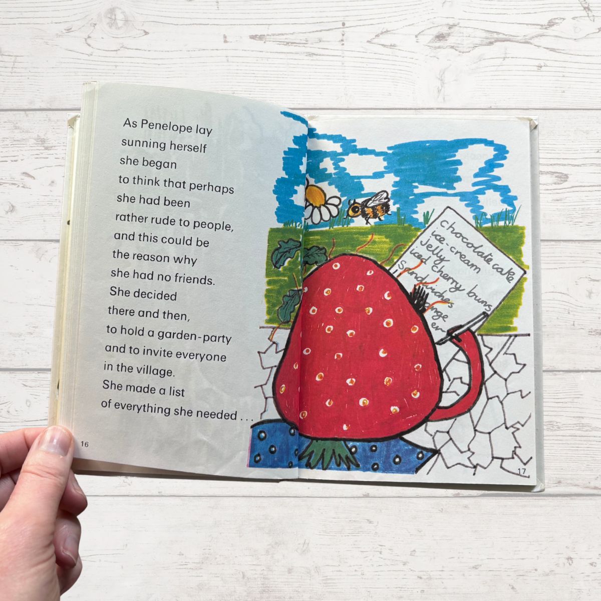 Colourfully illustrated childrens book featuring a strawberry on a white surface 