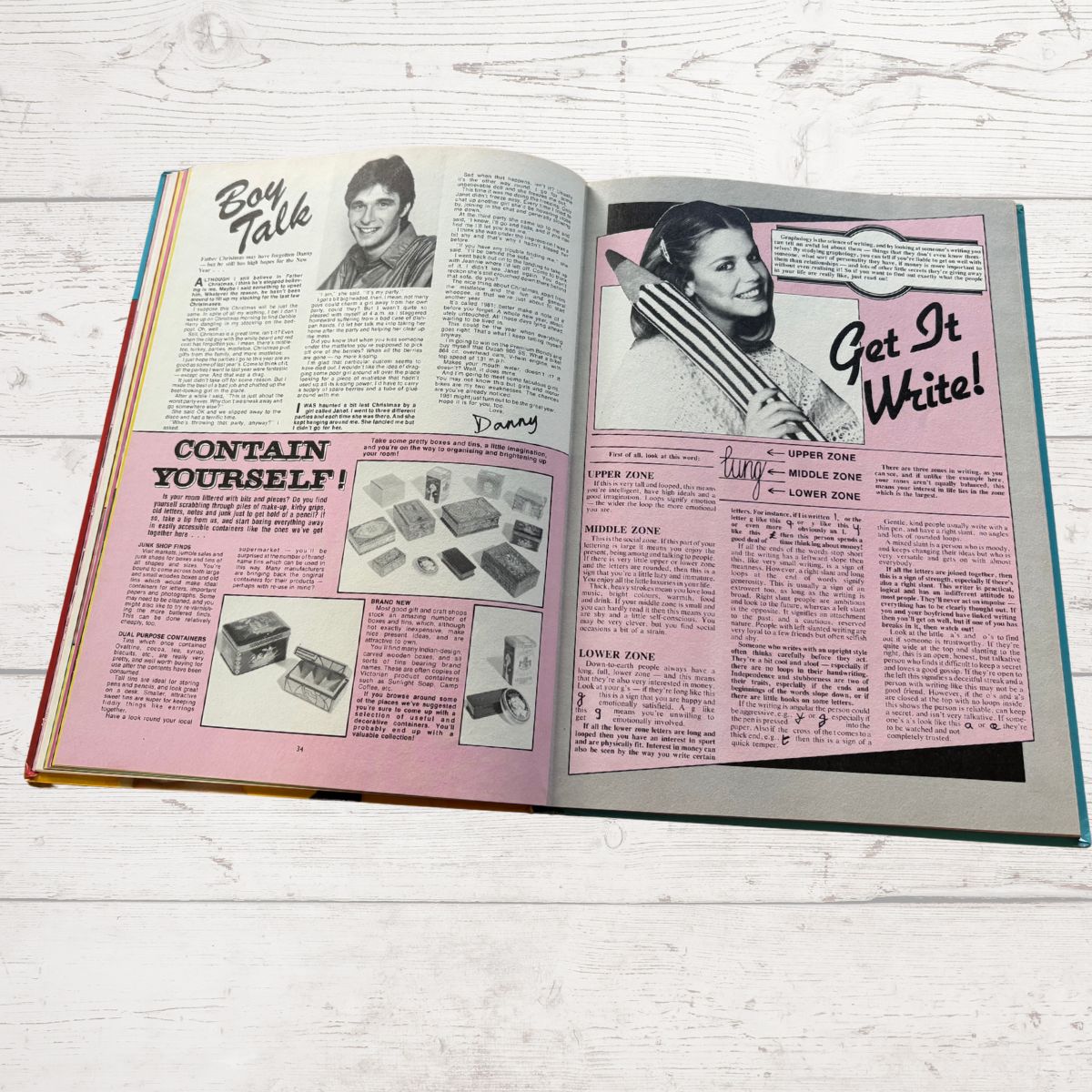 Open book with vintage-style magazine layout on a wooden surface
