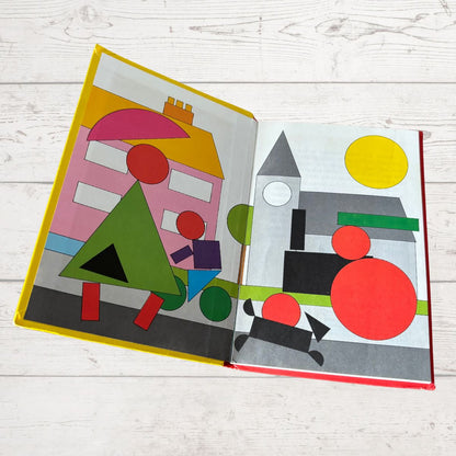 Children's book with geometric shapes on a wooden surface