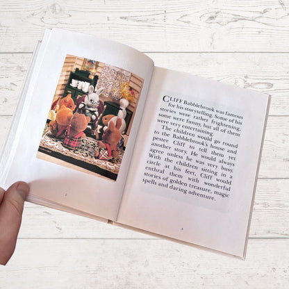 Open book with a picture of animals and text on a wooden surface
