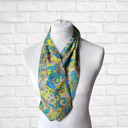 Patterned scarf on a mannequin against a white brick wall background