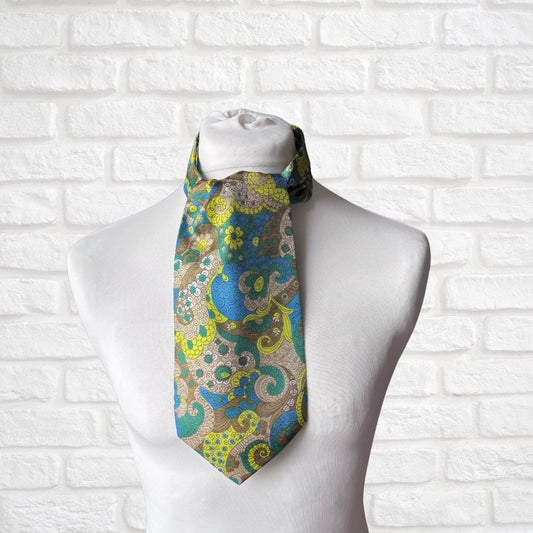 Patterned cravat  on a mannequin against a white brick wall background