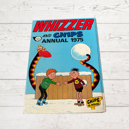 Vintage 'Whizzer and Chips Annual 1975' on a wooden surface