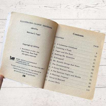 Open book showing contents page with text on a wooden surface