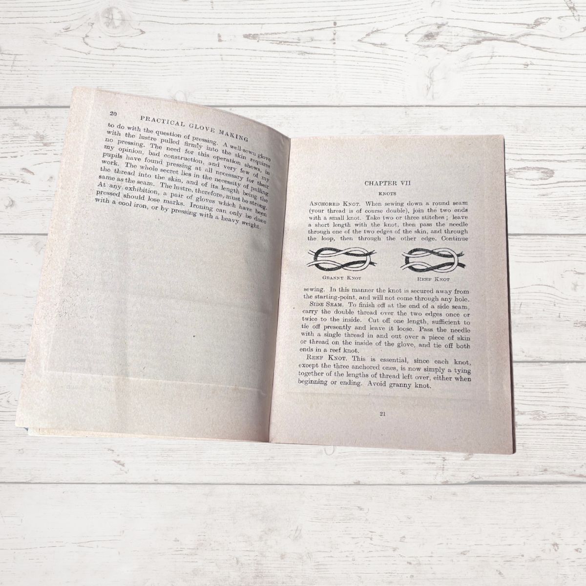 Open book on a wooden surface with visible text and decorative elements.
