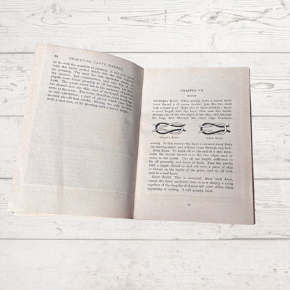 Open book on a wooden surface with visible text and decorative elements.