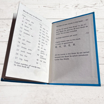 Open book with text on a wooden surface