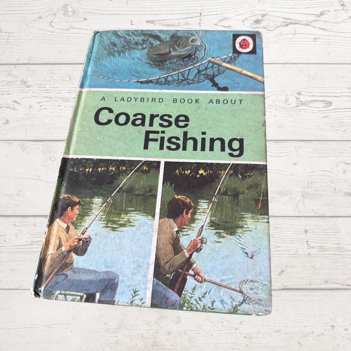 Vintage Ladybird book about coarse fishing on a wooden surface