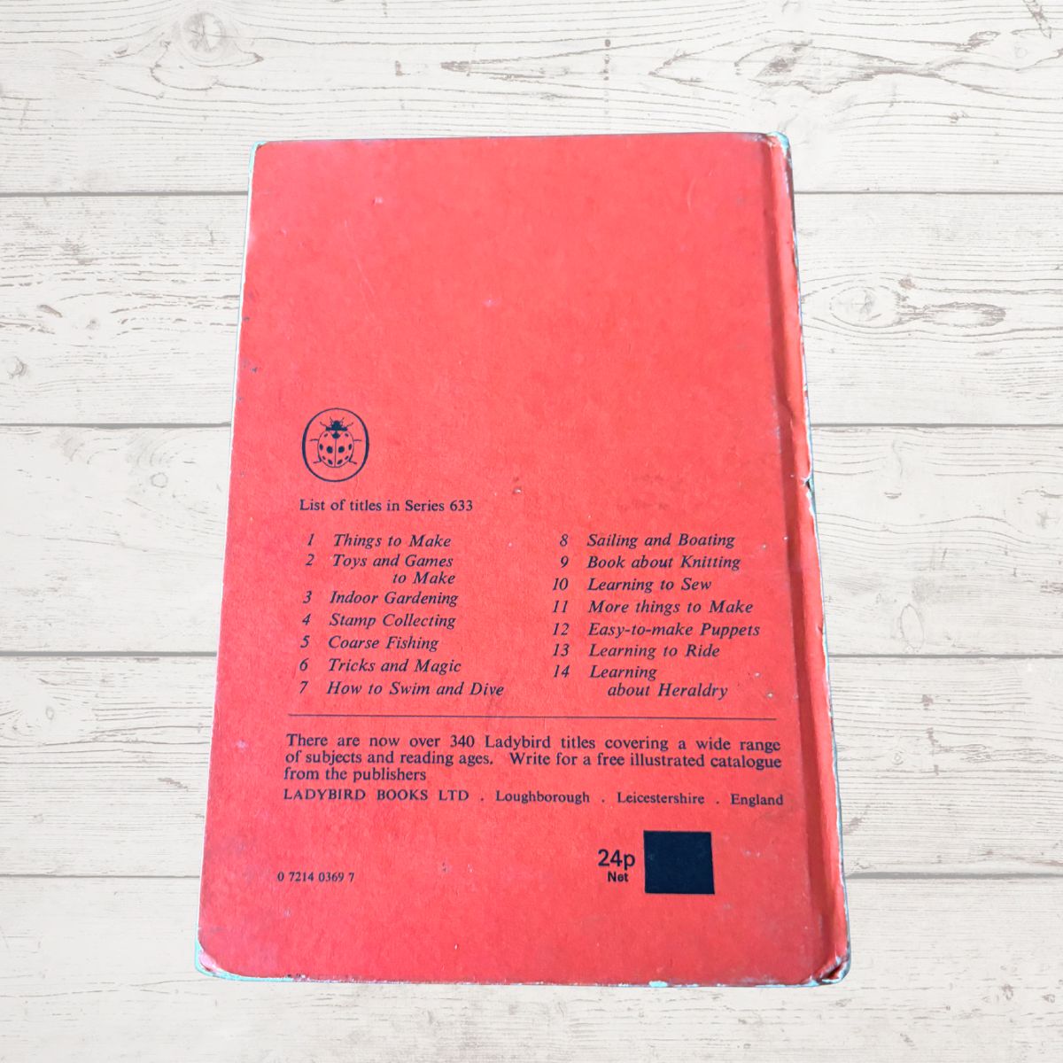 Red book with text on a wooden surface