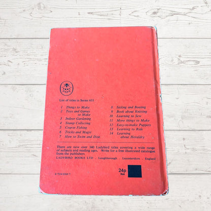 Red book with text on a wooden surface