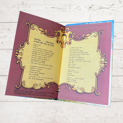 Open book with decorative cover on a wooden surface