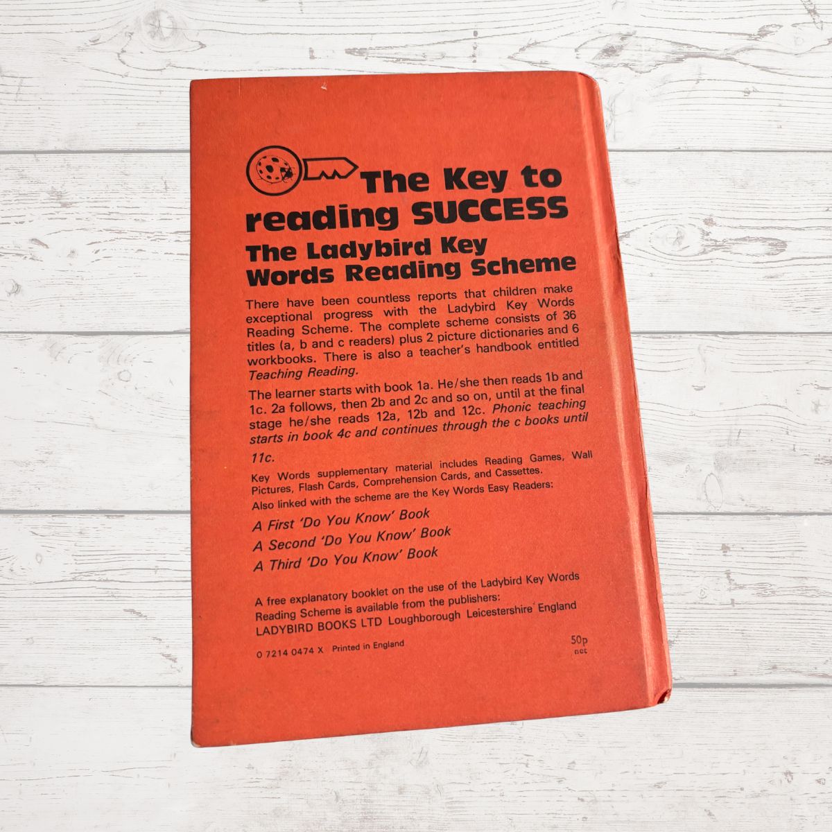 Red book titled 'The Key to Reading Success' on a wooden surface