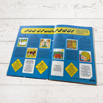 Open book with colorful illustrations and text on a wooden surface