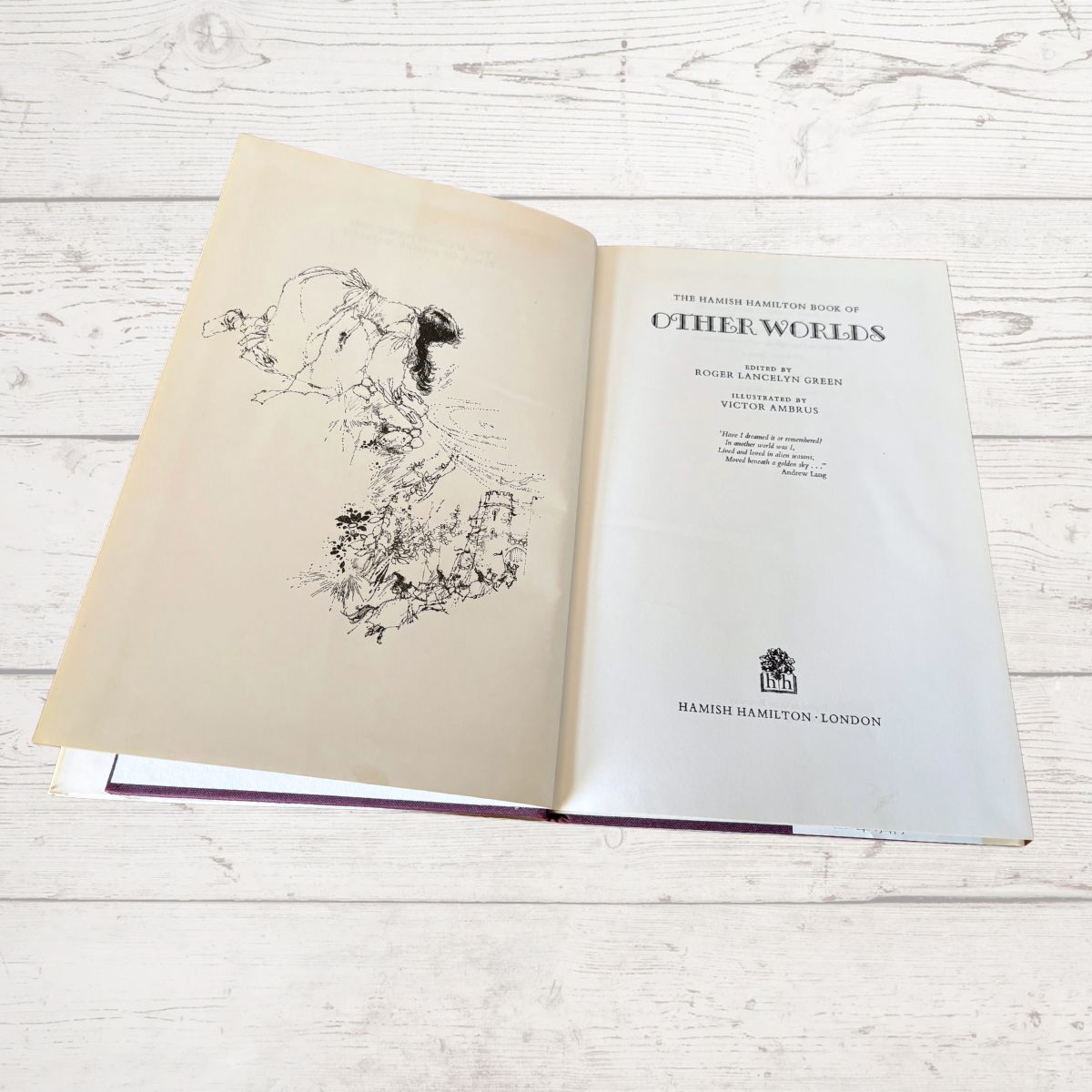 An open vintage book titled 'The Book of the Century: Otherworlds' 