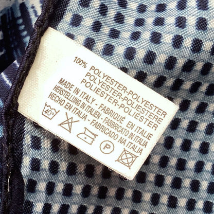 Clothing label on a fabric background with text and symbols