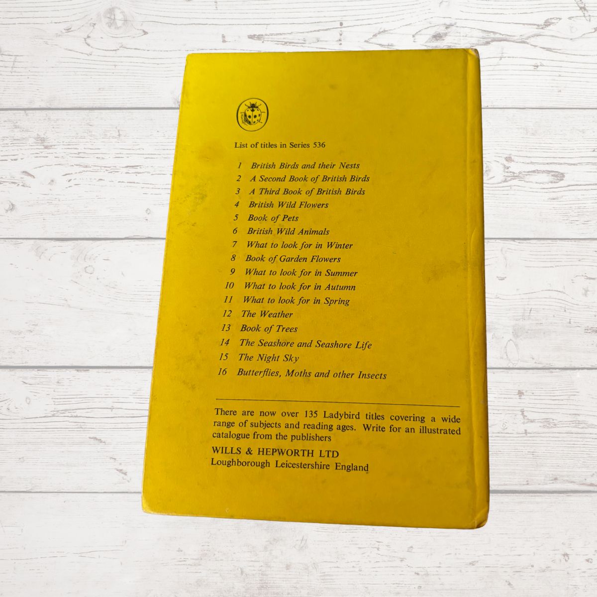 Yellow book with text on a wooden surface