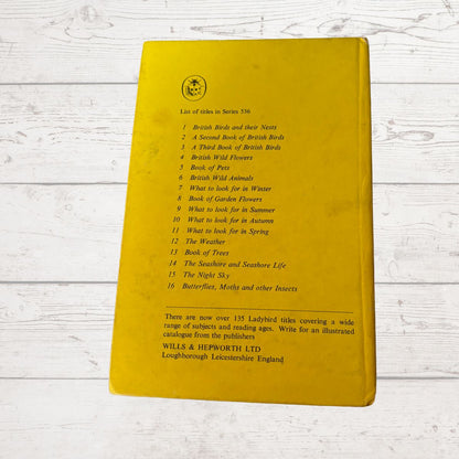 Yellow book with text on a wooden surface